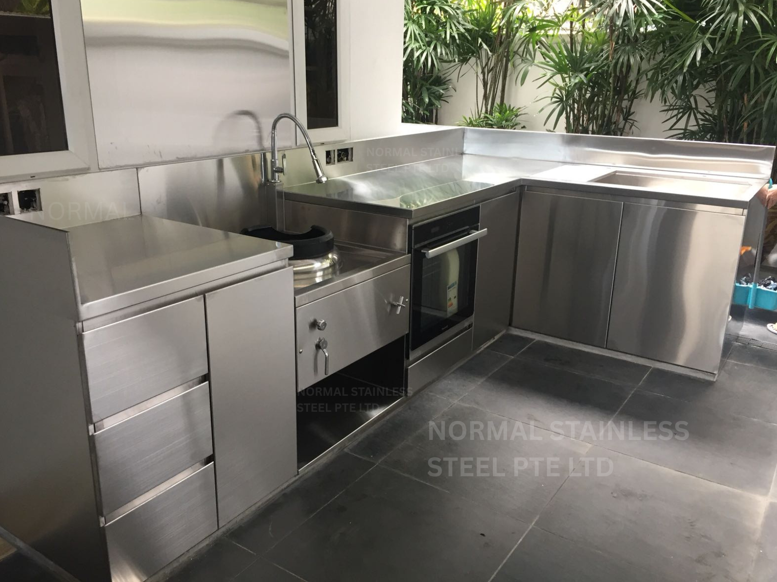 Outdoor stainless steel kitchen cabinet with sink, oven and kwali